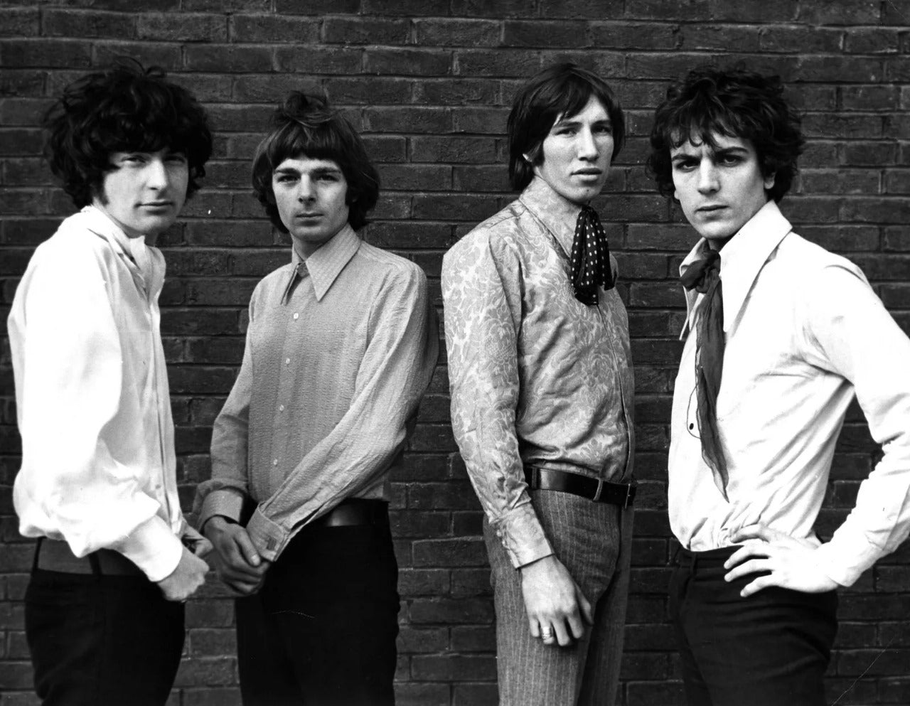Vintage black and white photo of Pink Floyd band members promoting Pink Floyd band t-shirts collection