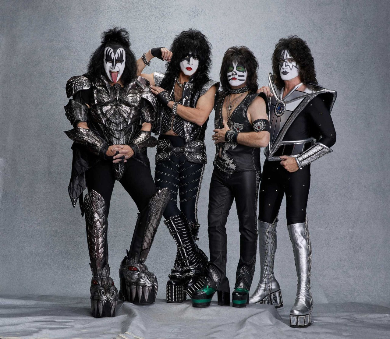 KISS band members in iconic makeup and costumes promoting classic rock band t-shirts collection